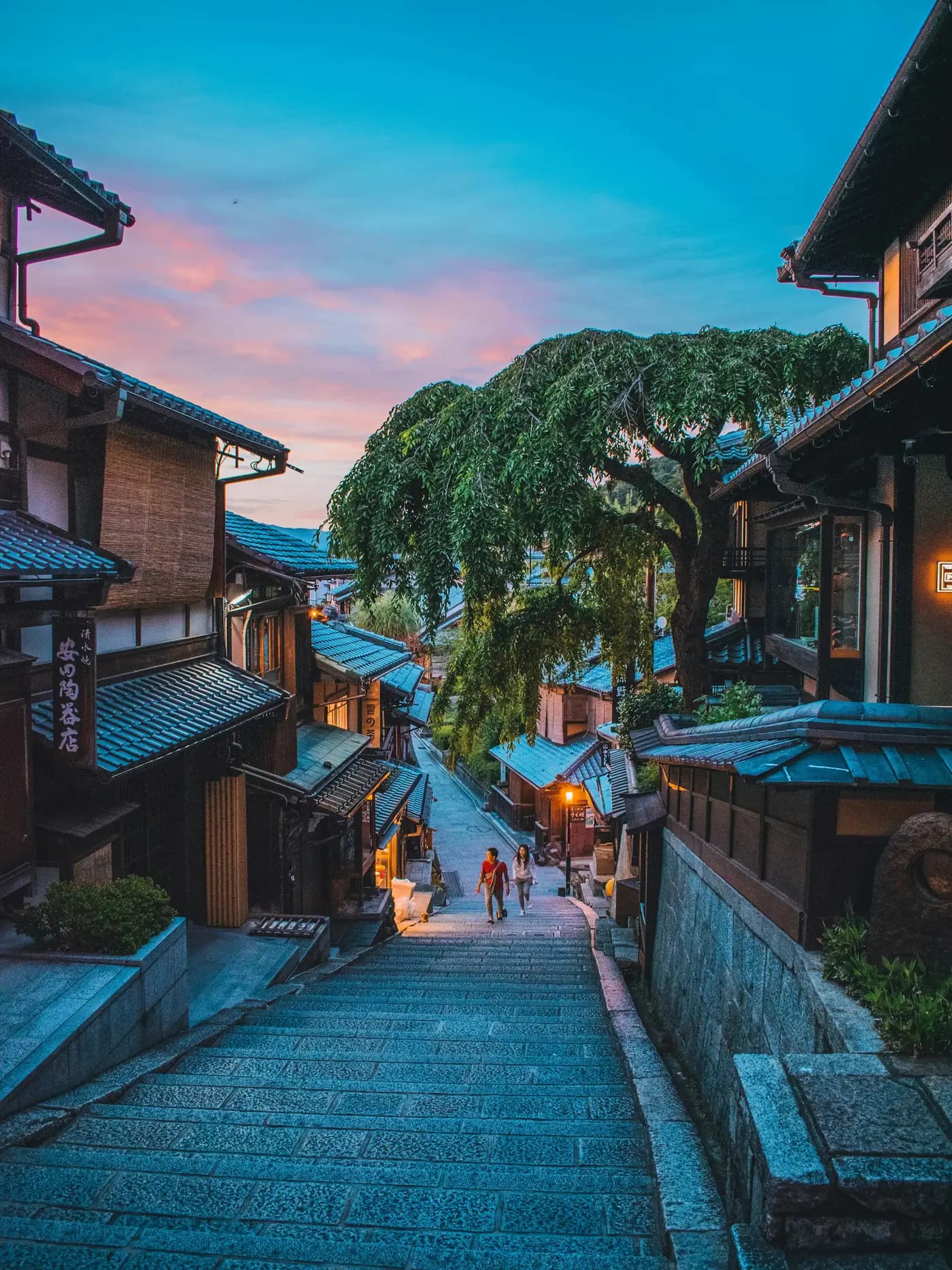 An old stone street of wooden houses in Kyoto at dusk